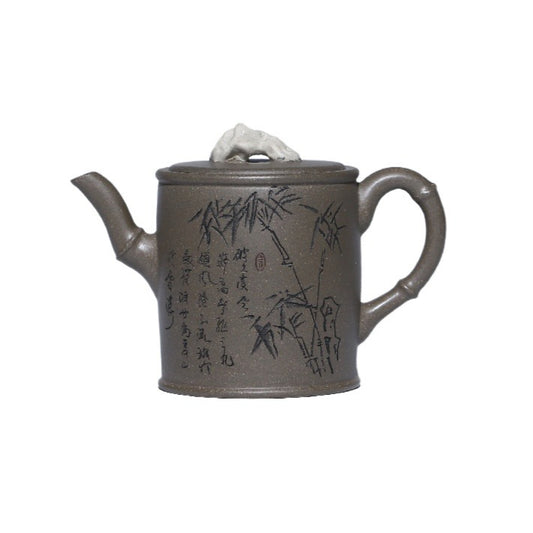 Grey-brown cylindrical teapot with bamboo decoration, on a white background.